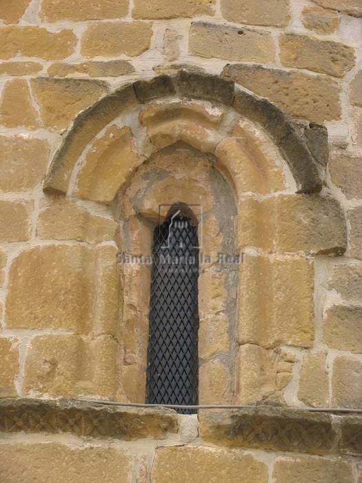 Vista exterior de una ventana lateral apuntada del ábside