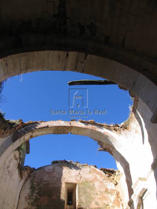 Detalle interior de los arcos de la nave y del deterioro existente desde los pies